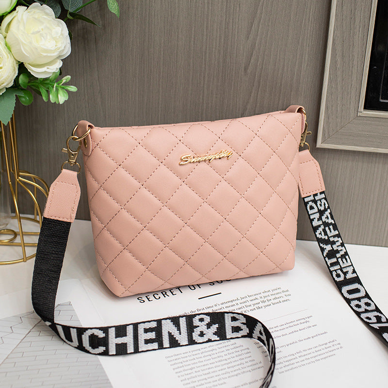 Pink quilted handbag with a black strap on a surface with flowers 
stylish clutch bag
designer-inspired clutch
party clutch purse
chic shoulder clutch
trendy women's handbag