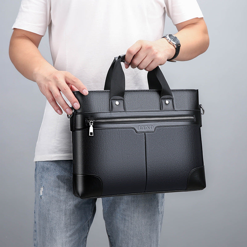 Person holding a black leather briefcase
stylish men's briefcase
professional messenger bag
men's office accessory
durable business handbag
executive office bag
premium men's work bag