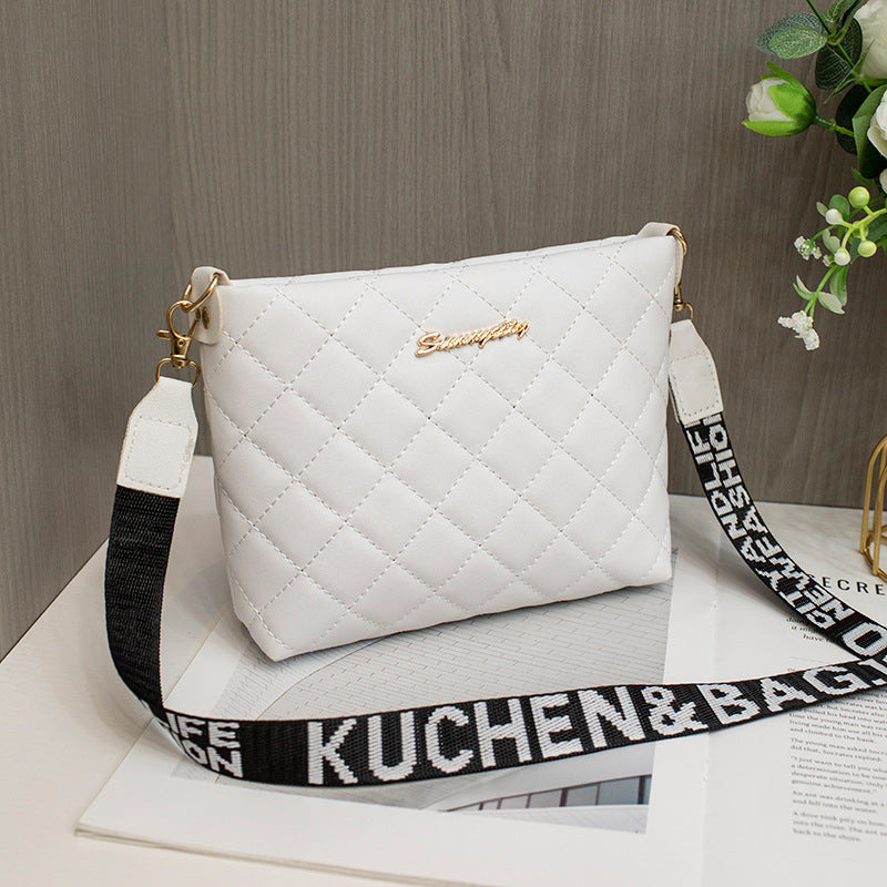 White quilted handbag with a black strap
stylish clutch bag
designer-inspired clutch
party clutch purse
chic shoulder clutch
trendy women's handbag